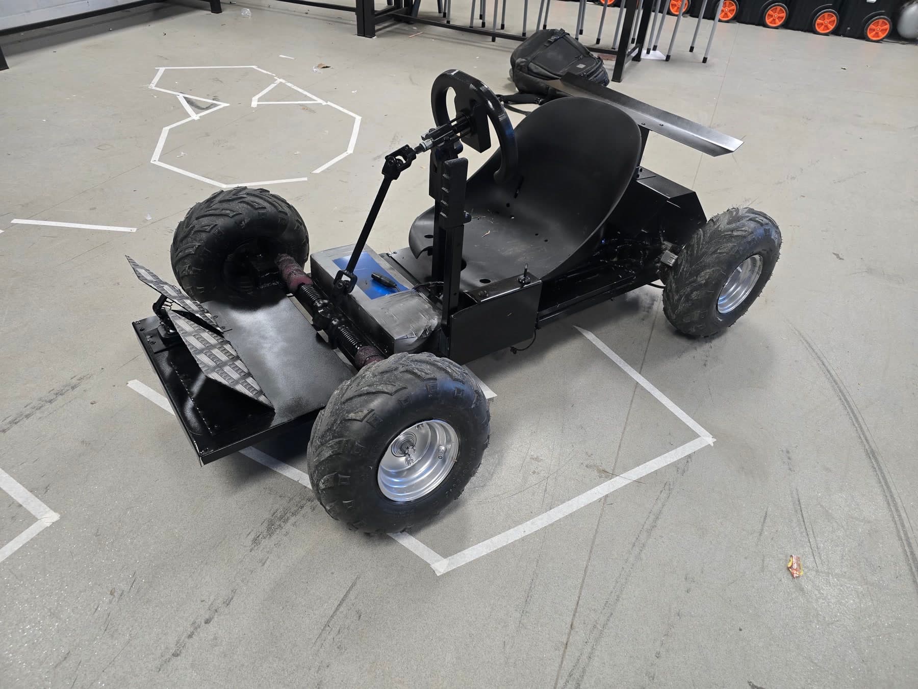 Completed custom black go-kart photographed in the school workshop without identifiable people