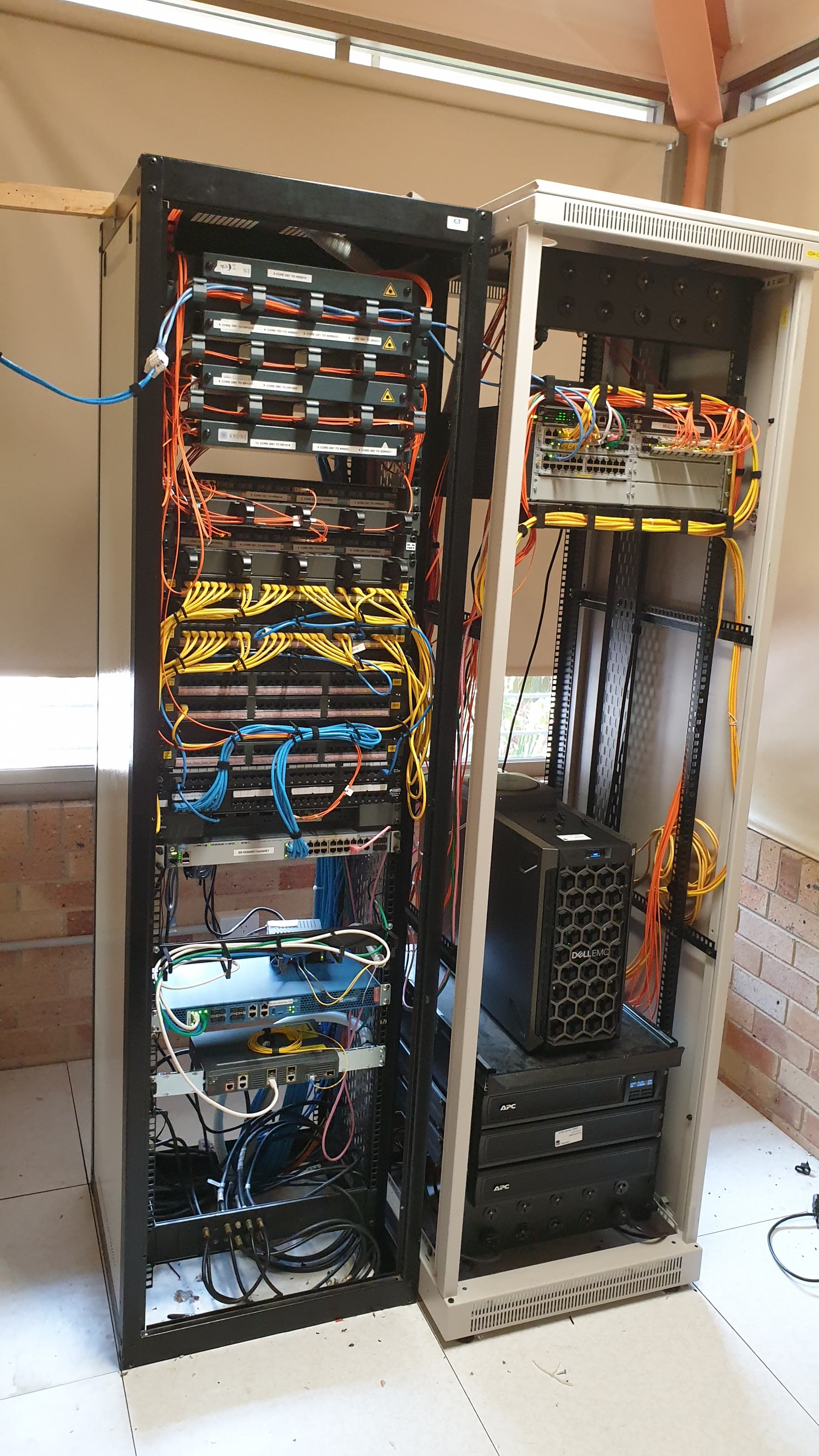 School fibre, switching, server and power equipment arranged across two network racks