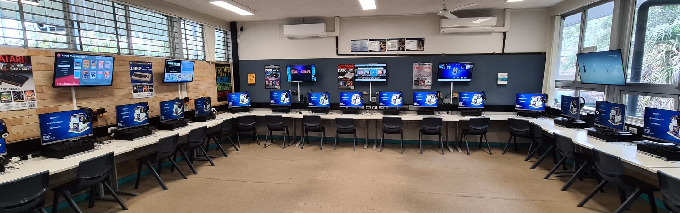 Panoramic view of the completed A12 computing room with a full ring of workstations and wall displays